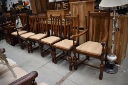 An early 20th Century set of six (four plus two) rail back dining chairs having applique to centre