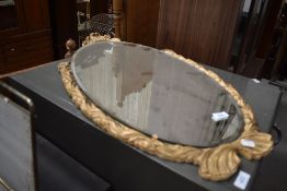 A vintage gilt frame oval wall mirror