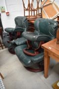 A pair of Ekornes Stressless lounge chairs with footstools