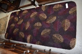 A vintage rug size carpet piece having rounded edges