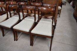 A set of six 19th Century Regency style railback dining chairs having later upholstery