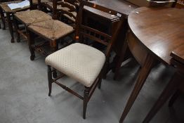 A Victorian stained frame spindle back bedroom chair having later upholstered seat