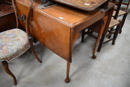 A mid 20th Century walnut and ply drop leaf table on cabriole legs