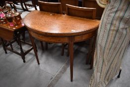 A 19th Century yew wood and crossbanded fold over games table having satinwood inlay and square