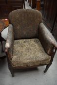 An Edwardian mahogany and inlaid upholstered armchair, good for a restoration project