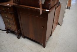 An early 20th Century Singer treadle sewing machine in cabinet, with some accesories