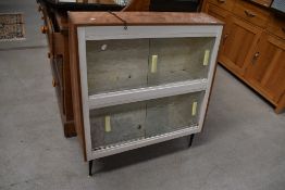 A 1950's 60's atomic style glazed book case or utility cupboard