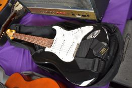 A vintage (brand) Stratocaster copy electric guitar with soft gig bag