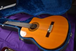 A Jasmine by Takamine, model number EC28C (Electric Classical Cutaway) in plush lined hard travel