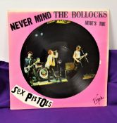 A copy of the Sex Pistols ' never mind the bo**cks ' picture disc - some light fade to the