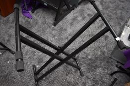 A folding keyboard stand with pin lock style mechanism