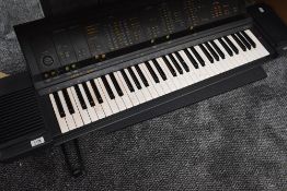 A vintage Yamaha PS-6100 keyboard, stand damaged