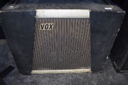 A vintage speaker cabinet, labelled Vox, fitted with Goodmans Audium speaker