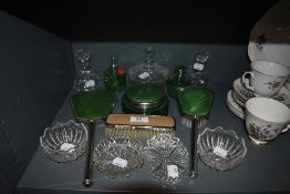 A selection of dressing table items including green enamel set having green glass bottles