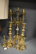 Five pairs of brass cast candle sticks or stems and a larger five branch candelabra