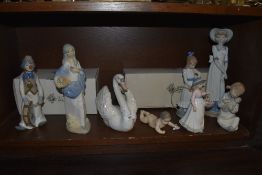 A collection of eight Lladro, Nao an similar figurines and studies including Nao Girl with Dog and
