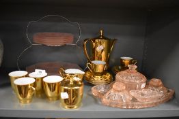 A pink glass art deco cake server and a similar dressing table set, also a gilt coffee service.