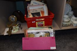 A box of vintage sheet music and some knitting patterns.