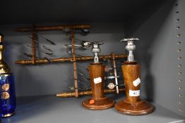 A selection of collectable display spoons and a pair of candle sticks having wooden bases