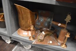 A selection of copper wares including crumb tray, water jug, candle sticks and scoop