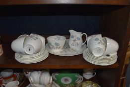A collection of Wedgwood having blue rose pattern included are cups and saucers, plates and more.
