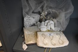 A bridal vale and two white and sequin hand or clutch bags
