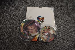 A selection of vinyl LP records and 45rpm singles, the majority being picture discs, including