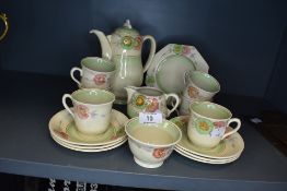 An art deco styled part tea service by Clarice Cliff having hand painted floral scenes
