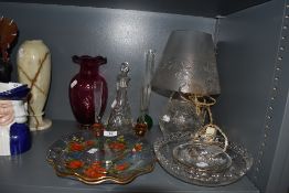 A selection of glass wares including posy vase cranberry vase and cut glass lamp