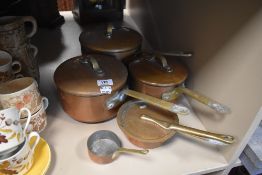Five vinatge copper pans and a flat iron.
