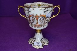 A Royal coronation twin handle cup or trophy by Aynsley on a cream ground in fine condition