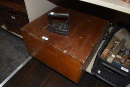 A vintage tool chest containing a selection of items including planes,saws,sharpening stone and