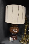 A mid century pottery lamp having genuine vintage shade to match