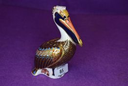 A figure study by Royal Crown Derby of a brown Pelican having gold stopper to base