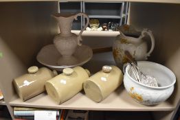 A selection of stone hot water bottles, chamber pot, jugs and wash bowl.