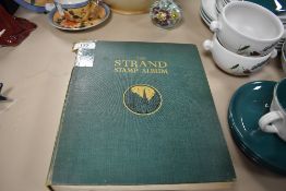 A vintage 'The Strand stamp album' containing a selection of world interest stamps.