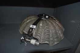 A ceiling mounted light fixture or fitting having sea shell style pressed glass