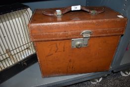 A vintage hard bodied tan leather carry case or box