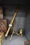 A brass bodied telescope with fitted stand and a similar brass cased theodolite