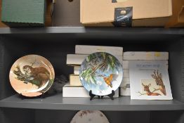 A selection of ceramic display plates having nature scenes by Wedgwood