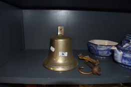 A vintage brass cast fire or door bell
