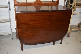 A reproduction Regency style mahogany gateleg table having fluted legs