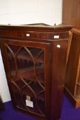 A 19th Century mahogany corner display cabinet inlaid detailing to door, approx width 77cm