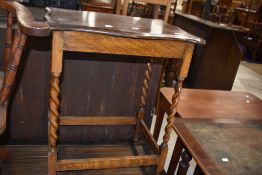 An early 20th Century oak occasional table on twist frame, width approx. 60cm, having shaped top