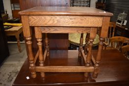 A traditional oak part nest of two tables