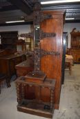 A Period oak hall stand having central mirror , black forest influences