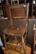 A traditional kitchen chair having elm seat on beech wood frame