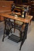 A 19th Century Singer treadle sewing machine in cast and oak frame, nice example