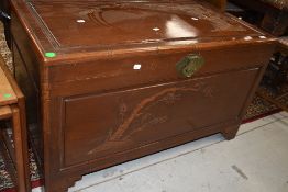 An Oriental bedding box having carved decoration depicting bamboo and prunus blossom, dimensions