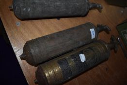 Three antique fire extinguishers.